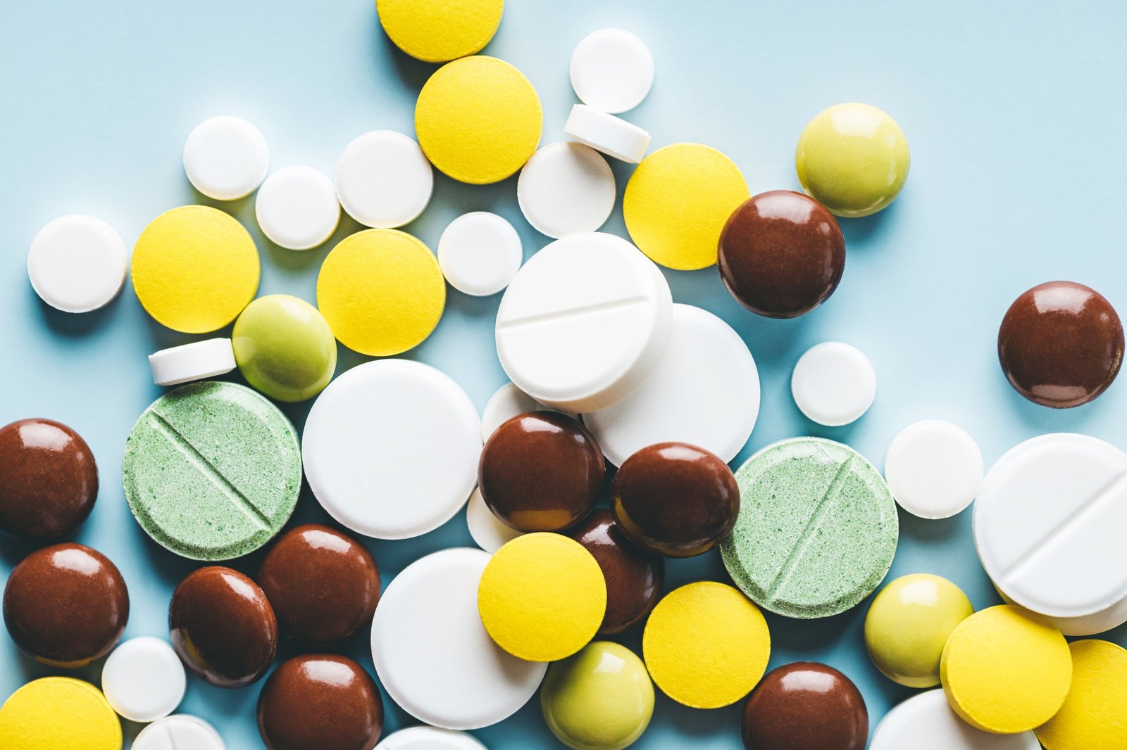Various pills on Blue Background.