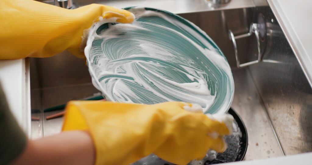 Wash dishes in kitchen at home